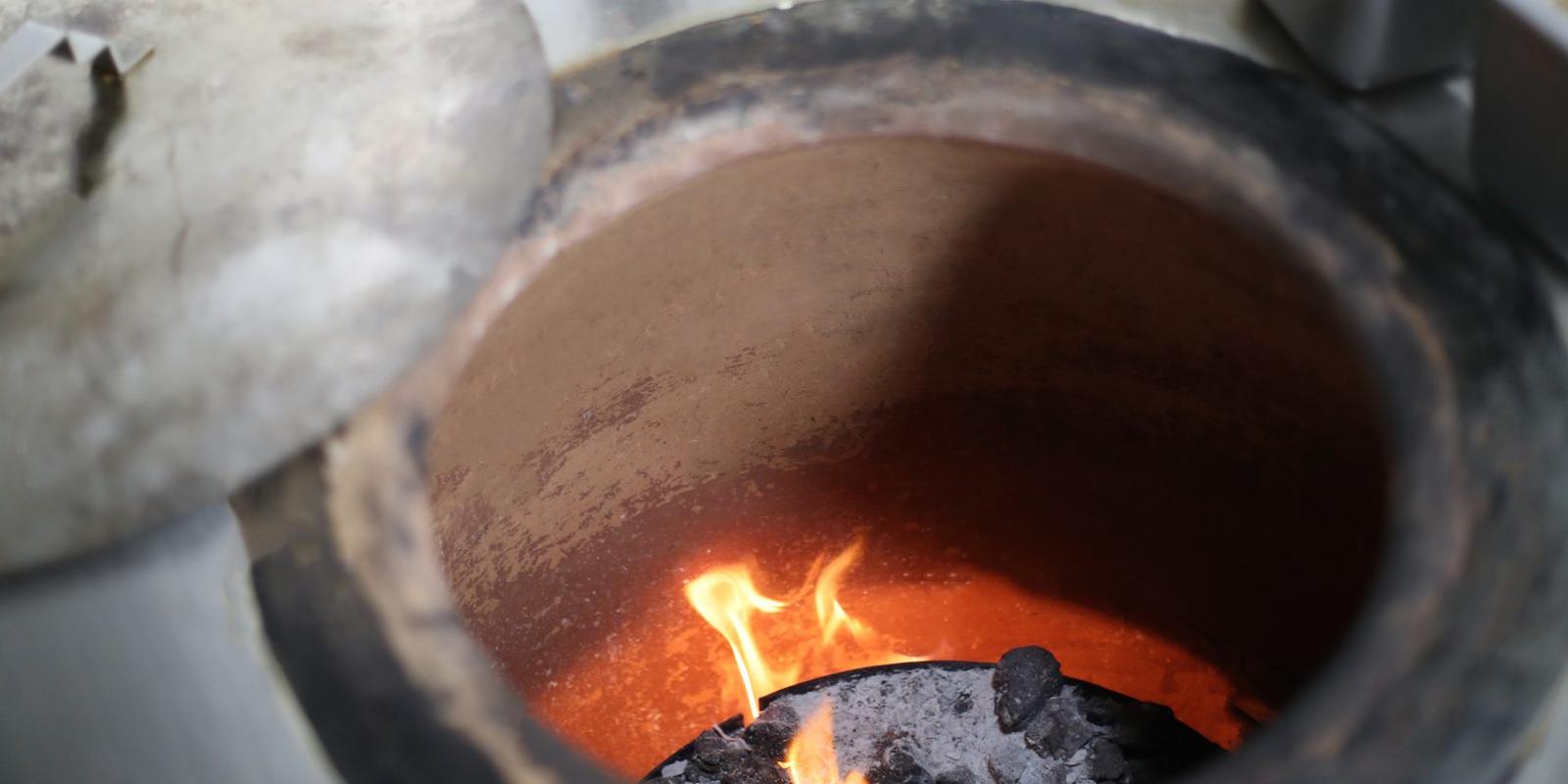 Charcoal fire glowing inside the clay wall of a GULATI tonir